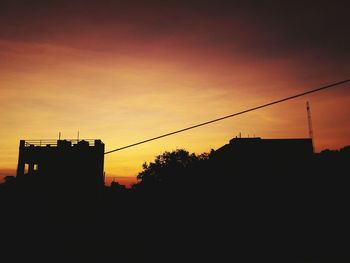 Silhouette buildings against sky during sunset