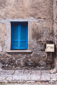 Low angle view of window on wall of building