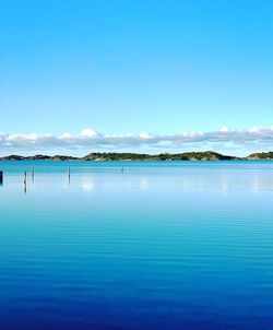 Scenic view of sea against blue sky