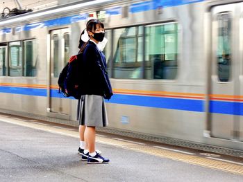 Full length of woman on train at railroad station