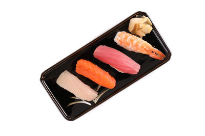 Close-up of sushi in plate against white background