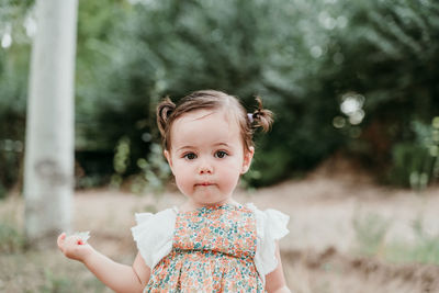 Portrait of cute girl standing outdoors