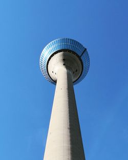 Low angle view of communications tower against sky