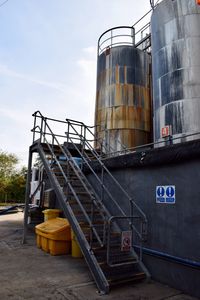 Low angle view of factory against sky