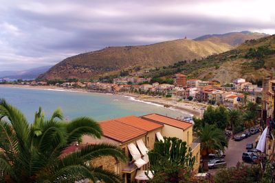 High angle view of sea with buildings in background