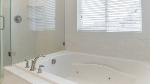 Low section of woman standing in bathroom