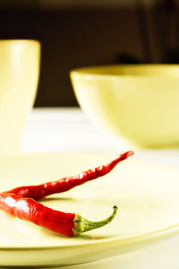 Close-up of red chili peppers in bowl on table