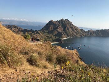 Scenic view of sea and mountains against sky