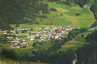 High angle view of trees and houses on field