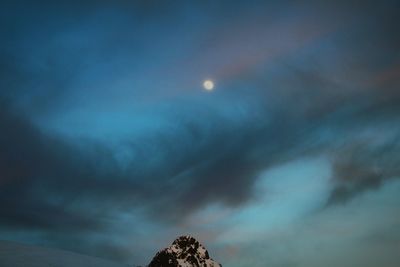 Low angle view of cloudy sky at night