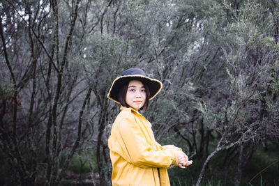 Portrait of woman standing at park