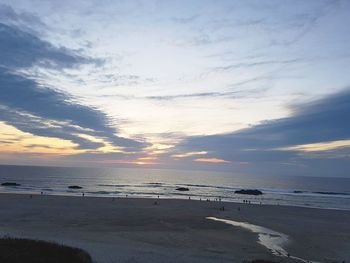 Scenic view of beach against sky during sunset