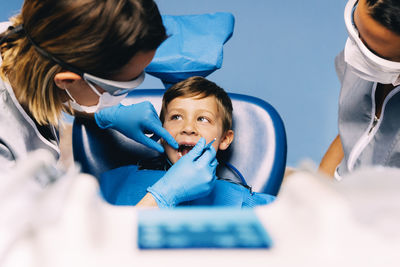 Dentists examining patient in clinic