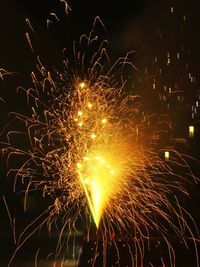 Low angle view of firework display at night