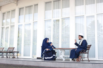 People sitting in front of office building