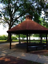 Gazebo by trees against sky