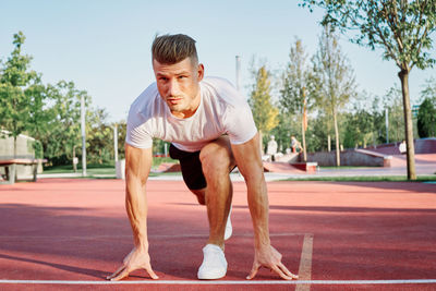 Side view of man exercising on field