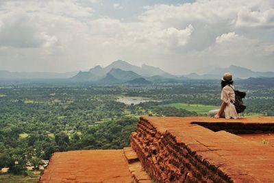 Rear view of woman on landscape against mountains