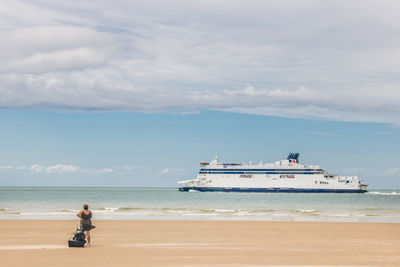 Man on beach against sky