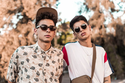 Portrait of young men wearing sunglasses