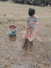 High angle view of boy standing in basket