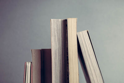 Close-up of books against gray wall