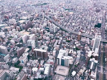 High angle view of crowd and buildings in city