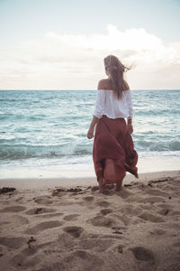 Rear view of man standing on beach