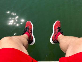 Low section of man against water