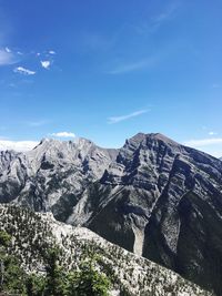 Scenic view of mountains against blue sky