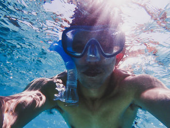 Young man swimming in pool