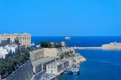 Ferry leaving a harbor of valletta on malta