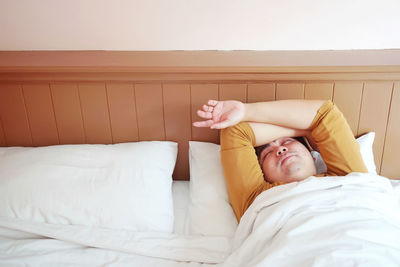 Young woman lying on bed at home