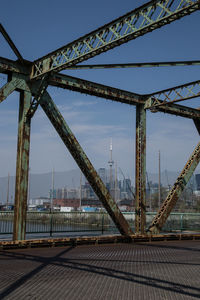 Bridge over river against sky in city