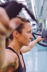 Woman exercising with resistance band at gym