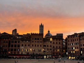 Buildings in city at sunset