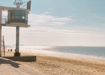 Lifeguard hut on beach against sky