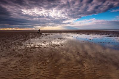 Scenic view of beach against sky during sunset