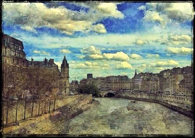 Buildings against cloudy sky