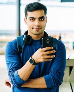 Portrait of young man using mobile phone