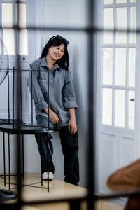 Portrait of young woman standing in office