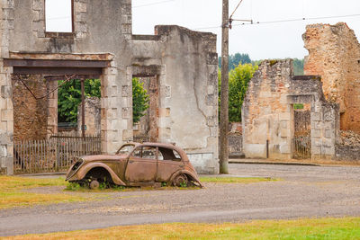 Old damaged car in city