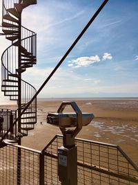 Lifeguard hut on beach against sky