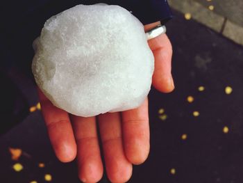 Close-up of hand holding snowball