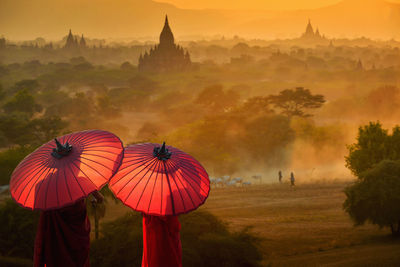 Monk standing with holding umbrella, bagan mandalay myanmar