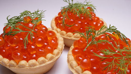 Close-up of red caviar on white background