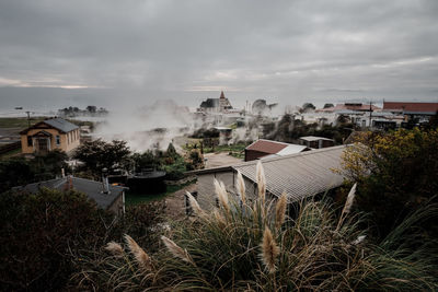 Panoramic view of buildings against sky with geothermal activity