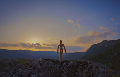 Rear view of man standing on cliff