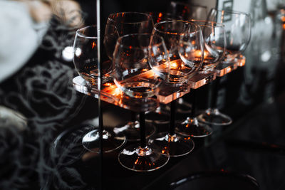 Close-up of wineglasses on rack