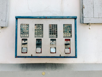 Close-up of gumball machine on wall